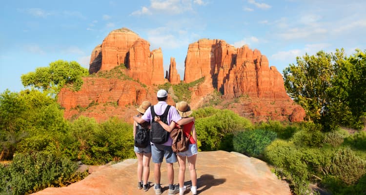 family in hiking gear in sedona viewing the red rock formations