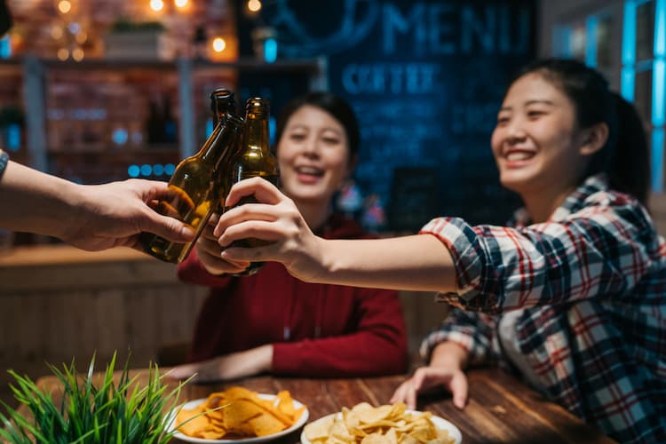 Friends toasting at bar