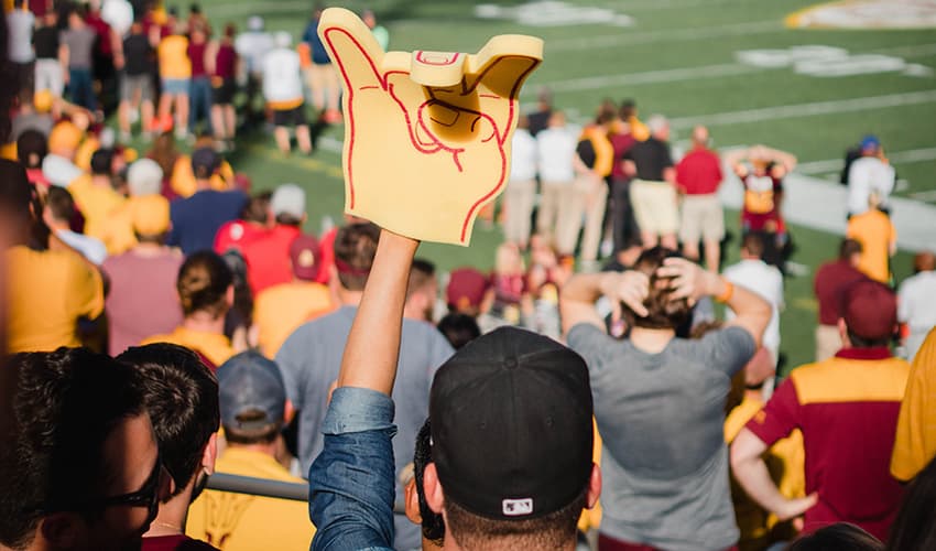 Football fans cheer at a game in Phoenix, AZ