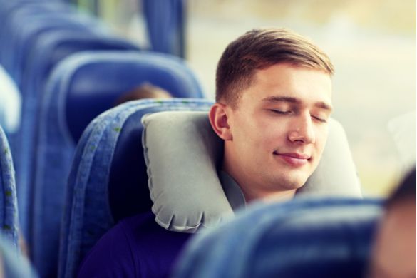 a man sleeping on a charter bus