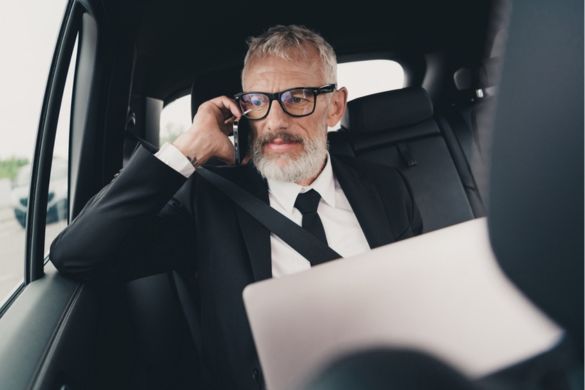a professional talking on a phone in a vehicle